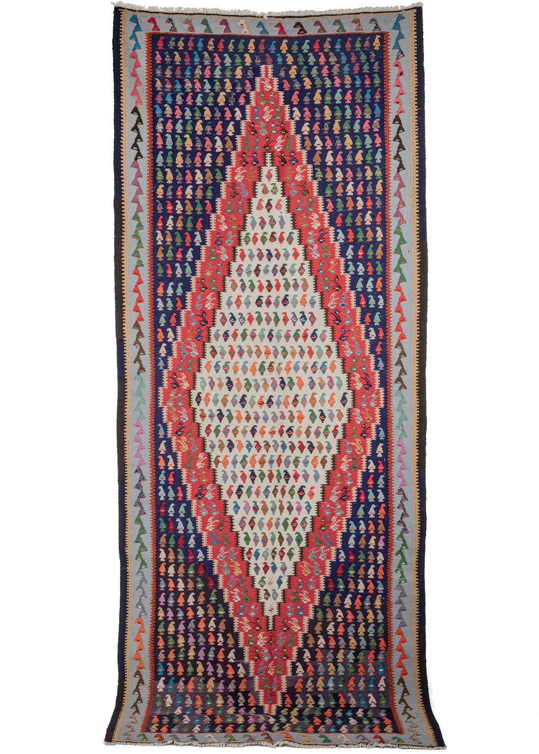 NW Persian kilim runner featuring a bold central diamond woven in white and red on variegated purple field encapsulated by a thin pale blue border. Polychrome botehs (paisley) triangles and birds fill all the open space in blues, reds, purples, orange, greens and yellows.