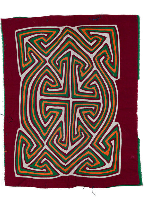 Panamanian applique quilted Kuna Mola cloth featuring vibrant tones of burgundy, green, orange, and white. A graphic medallion features intersecting latchhooked motifs. The highly contrasting colors add interest and excitement to the piece. 