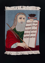 Vintage Tabriz rug handwoven in NW Iran, featuring Moses holding the stone tablets with the 10 commandments written in Hebrew (which is more unusual). The skill of the weaver is showcased by the complexity of the design and the painterly quality of the piece.  In perfect condition, with original fringe; signs of wear consistent with age. Thickly woven, with a sturdy handle. Sides have leather strips on the back to prevent curling and prolong longevity.