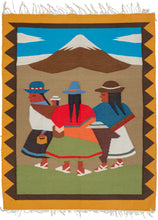 peruvian tapestry featuring a depiction of Andean life with three women walking in front of a snow-capped mountain. One woman has a small child strapped to her. They are all wearing traditional dress including distinctive hats. 