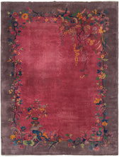 Antique Chinese deco rug featuring a bountiful blossoming vine that straddles the area where the otherwise unadorned lavender border hugs the open magenta field. The magenta field has two moments where the vibrant, polychrome design more deeply engages the field. One at the top right where the blossoms spill over and hang down and another a moment at the bottom left where a flower-filled vase sits atop a scholars stone.