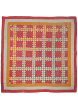 This Vintage North American Quilt features a grid composed of yellow and white diamonds on a red ground. The grid is framed by solid yellow, white and red borders. The whole quilt has been stitched together in a pattern of concentric diamonds adding another subtle layer of interest.