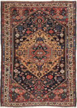 Bakhtiari rug featuring a concentric central medallion with fields chock full of various rosettes, leaves, and other abstracted forms in tones, red, pink, blue, green, ivory, and a spectacular amber yellow that completely steals the show. The cornices feature interesting speckled forms that are likely stylized vegetal forms but almost feel like mythological beasts. Framed by the main border of meandering palmettes on a camel ground and two minor borders of polychrome elongated PAC-man botehs. 