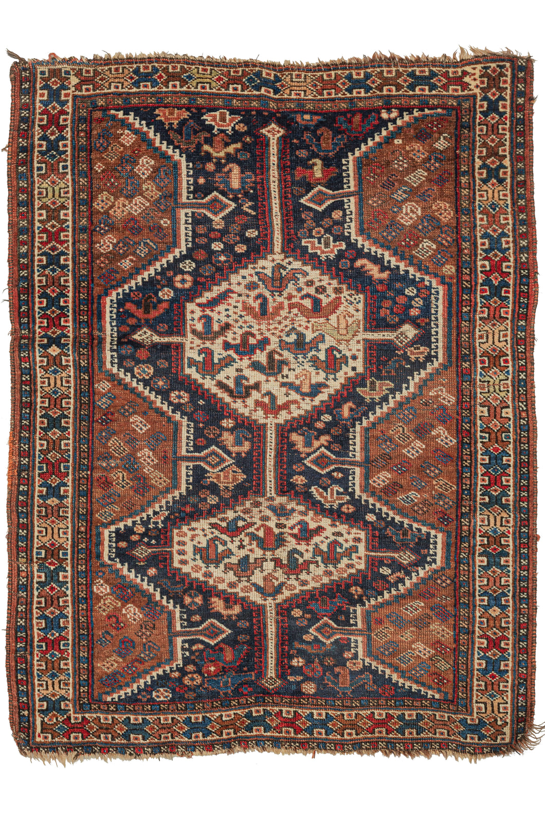 This Antique Khamseh Rug features two connected latch hooked medallions filled with abstracted birds atop a navy of ground chock full of more abstracted birds and rosettes and flanked by two scalloped edges filled with botehs on a rust ground. The whole is nicelhy framed by a bright polychrome border featuring a 