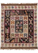 This vintage Signed Peruvian Kilim It features a central square of polychrome swan-like birds on a black ground surrounded by a series of concentric borders. They feature a band of butterflies on a white ground, various one-off geometric symbols on a black ground, and finally a border of birds of a different variety than what was utilized in the center. The top and bottom are finished with undyed brown skirt borders. The bottom skirt is signed by the weaver "Sllamocca".