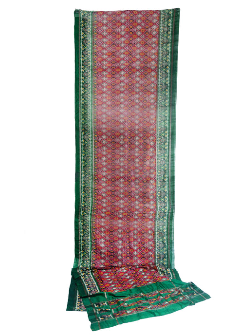 Silk Ikat woven Saree sari featuring patterning of diamonds, Xs, and rosettes in well contrasted red, green, yellow, purple, and white rendered in lustrous silk.