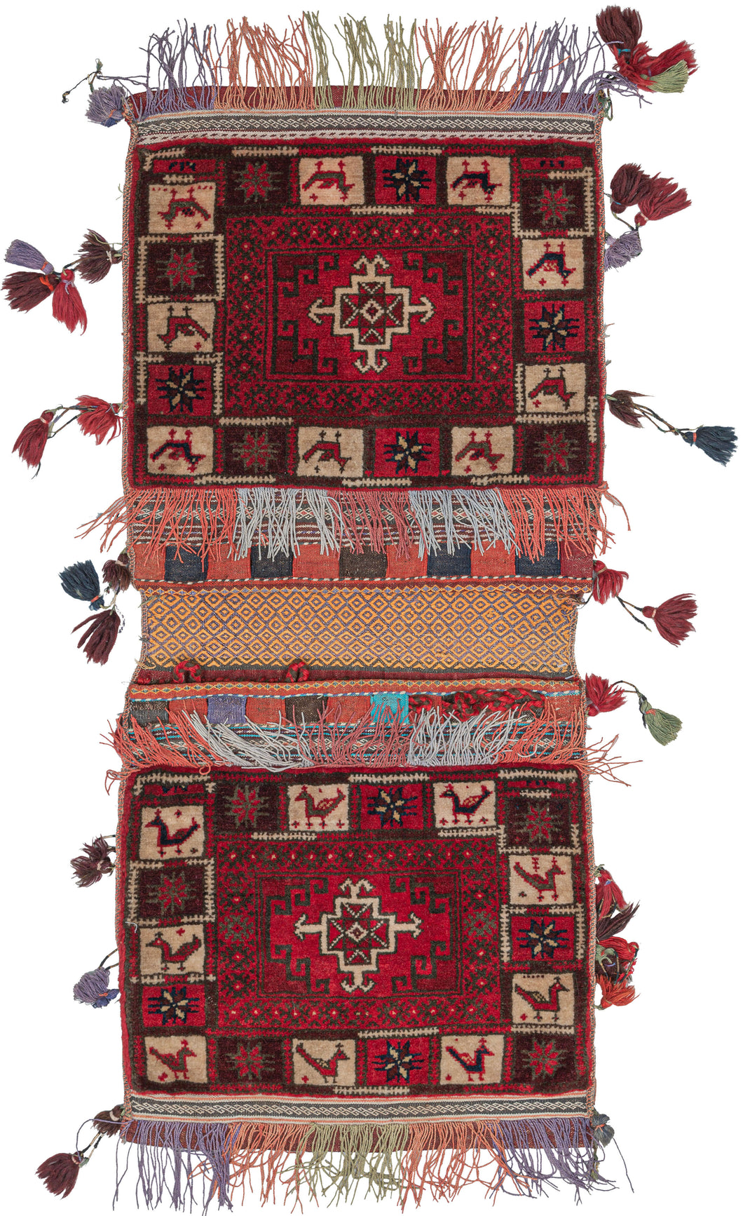 The bag face is a low and dense pile with a flatwoven back in a purple and yellow diamond pattern. The closure is composed of red and blue slit tapestry with braided loops. The bagface features a red, white, and brown geometric design, with a border featuring animals and stars. Multicolor fringe is on the tops and bottoms of both bag faces, with tassels along the sides. A truly whimsical piece. 
