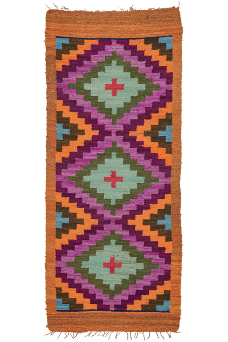 This Vintage Peruvian Kilim features three concentric diamonds with a 