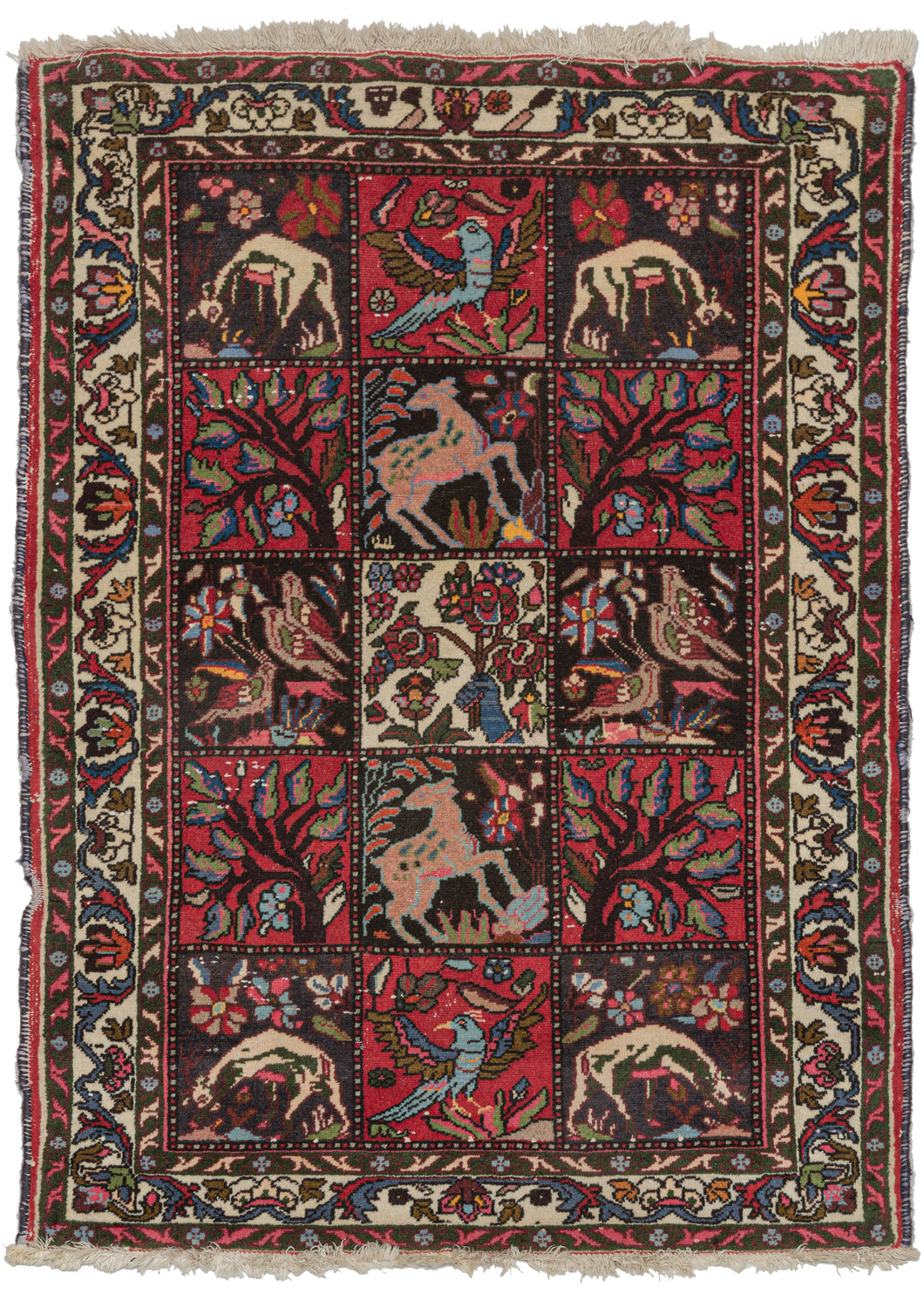 This Flora and Fauna Bakhtiari Rug features a classic grid garden design full of flora and fauna including deer, birds, and flowering branches. Of particular note is the central square which wonderfully and unexpectedly showcases a blue hand with pink nails holding a bouquet of fresh cut flowers.