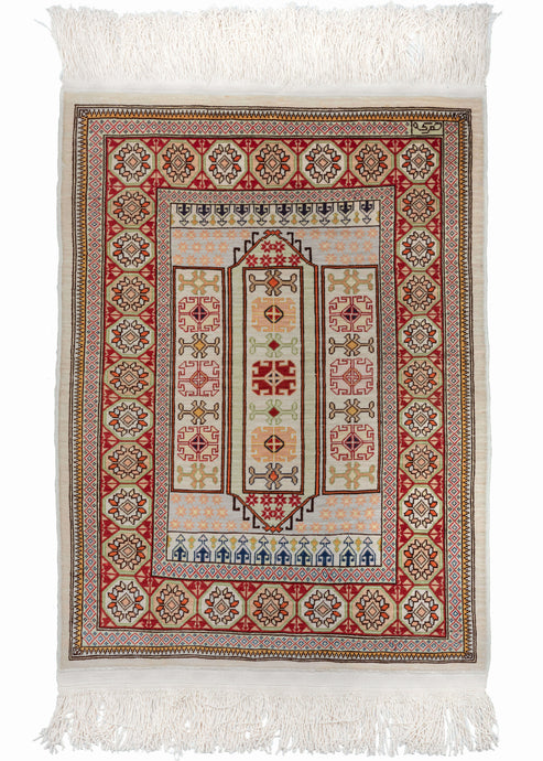Turkish Hereke silk rug featuring a field of three cartouches filled with tight geometric rosettes. The silk  pile accentuates exquisite tones of lilac, moss and apricot contrast, with brilliant red, lively indigo and soft ivory. The very precise and dense weave makes this rug exceptionally fine.