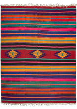 Turkish beach kilim featuring a very bright and cheerful color palette, with a horizontal stripe design and central geometric motifs. In excellent condition, signs of wear consistent with age.