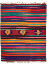 Turkish beach kilim featuring a very bright and cheerful color palette, with a horizontal stripe design and central geometric motifs. In excellent condition, signs of wear consistent with age.