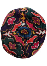 Uzbeki embroidered skull cap cross-stitched of silk into four main sections and features bright tones of green, purple, pink, and yellow. The edge of the skull cup is finished nicely with a thin border panel of opposing trident panels.