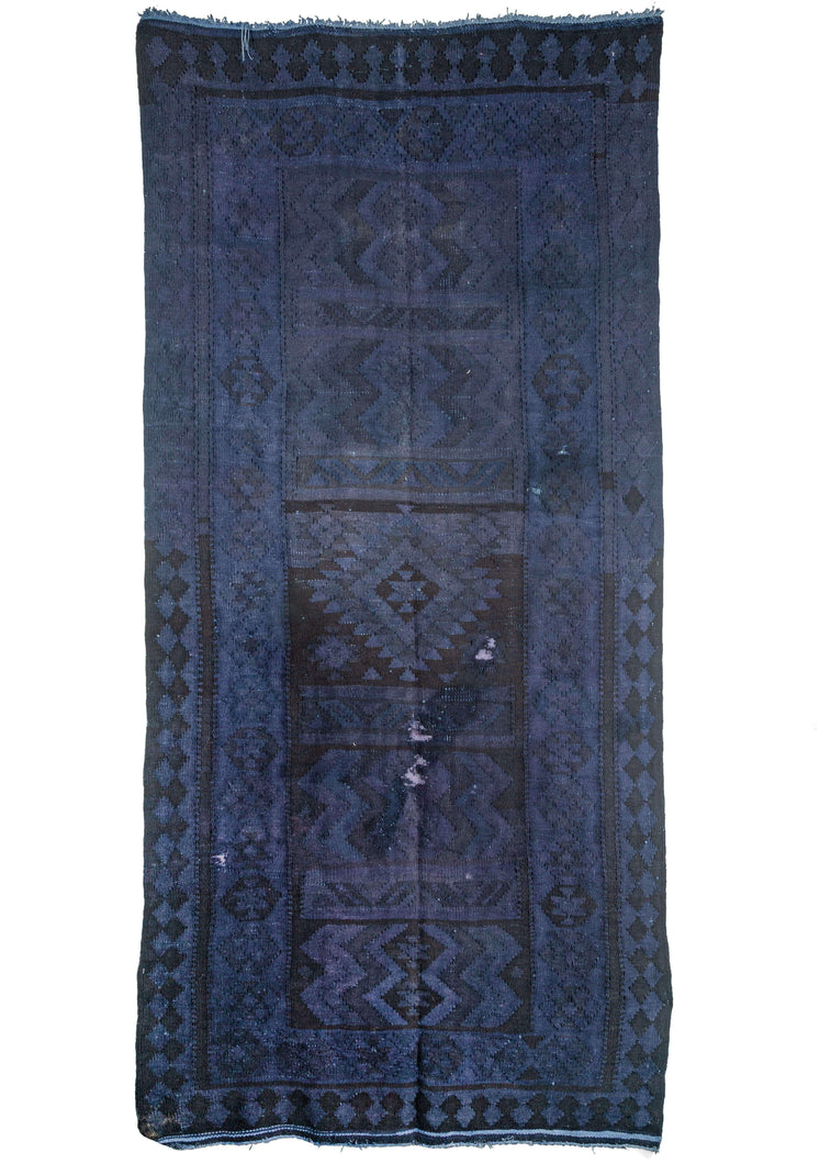 vintage Turkish kilim overdyed featuring a deep purple field. The underlying geometric pattern is still visible with hints of abrash distinguishable.