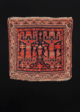 Northwest rug handwoven during the second quarter of the 20th century.  This quirky rug features a very unique and unusual geometric design in bright oranges and reds on a deep indigo field. The ivory border frames the design, giving the rug a very painterly quality. Would look fantastic as a wall hanging!  In very good condition, signs of wear consistent with age.