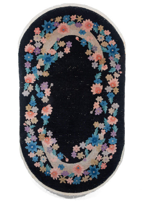 Vintage Black Oval Chinese Art Deco Rug with an open border of pastel flowers over crescent moons