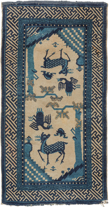 Feng shui The pictorial rug was handwoven in Mongolia during the early 20th century.  It features a mirrored design of a stag under a tree with a crane and bat flying above. The stag represents well-being, while the crane symbolizes a long life and the bat prosperity. The color palette is minimal with ivory, dark and light blues. The whole is framed by a tightly rendered fret border.