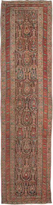 Antique Persian Serab runner featuring large-scale botehs growing on vines and surrounded by tiny rosettes on a chocolate ground. Framed by a main border of pulsating green 