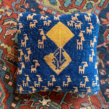 This Gabbeh pillowcase was recently handwoven in Southern Iran.   It features simple vegetal and zoomorphic patterning on big blocks of rich color.   With a densely woven pile making for a plush pillow.