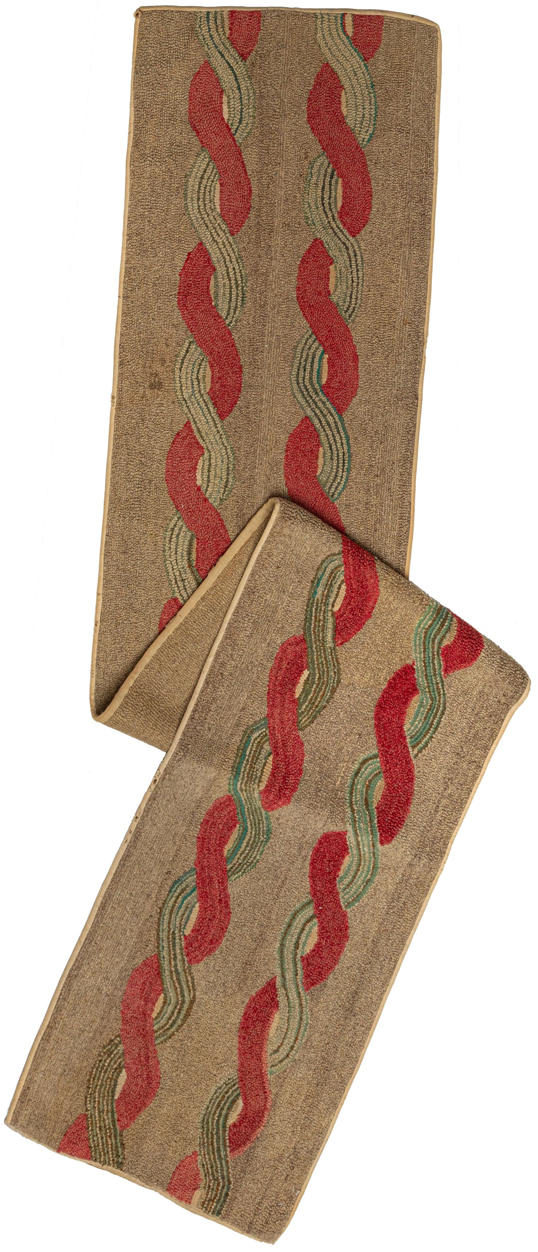 This Antique North American Hooked Runner features a straightforward but complex pattern of two interwoven scrolls on a camel ground. One scroll is a solid red and the other is striped green which accentuates the contrast and adds to the perceived dimensionality. The edges have been reinforced by thin beige binding.