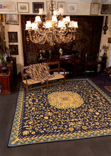Portuguese needlework rug from second quarter of 20th century. Ornate floral pattern in yellow, brown and green on indigo blue field. 